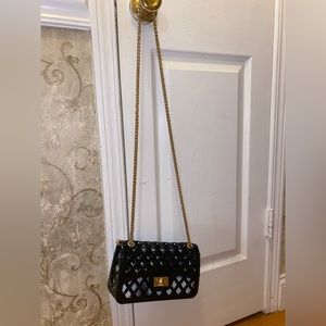 Black and gold pocket book. Never worn . Perfect condition